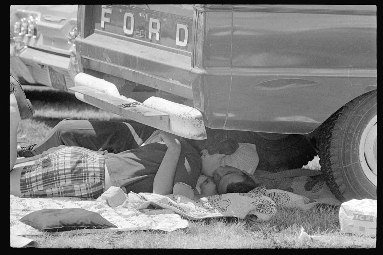 Joel Meyerowitz, Indy 500, Couple Under Car, Indianapolis, Indiana, USA, 1965